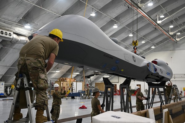 U.S. Air Force aircraft maintainers assigned to the 119th Wing positions an MQ-9 Reaper on to jacks to prepare for a landing gear swing at Andersen Air Force Base, Guam, Feb. 9, 2023. Placing the aircraft onto jacks allows the landing gear to swing down into place so maintainers can begin the assembly process. (U.S. Air National Guard photo by Senior Airman Christa Anderson) 