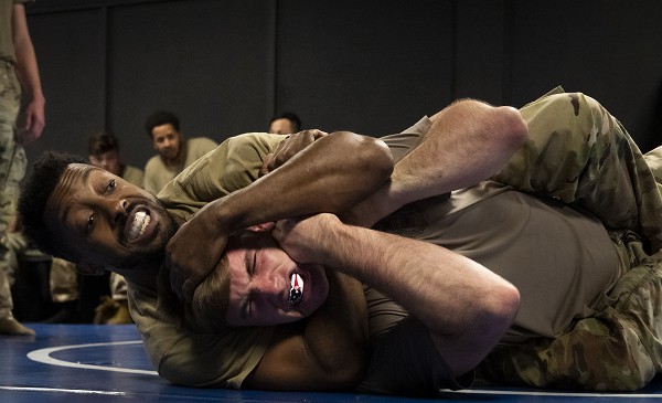 Staff Sgt. Jared Elliot, puts Airman 1st Class Hunter Warren, 96th Security Forces Squadron, in a choke hold during a training class Feb. 16, 2023, at Eglin Air Force Base, Fla. The class was part of a new consolidated training curriculum that combines the security forces unit’s requirements with combat-ready deployment exercises. (U.S. Air Force photo by Samuel King Jr.) 
