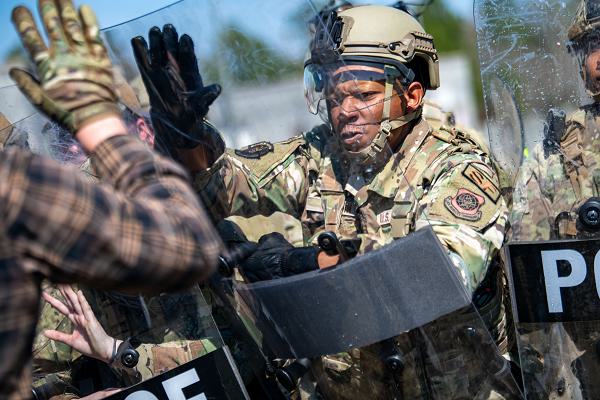 U.S. Air National Guard Security Forces Defender uses his shield during a simulated protest at PATRIOT 24, Camp Shelby, Mississippi, Feb. 21, 2024. PATRIOT is a Domestic Operations disaster-response training exercise conducted by National Guard units working with federal, state and local emergency management agencies and first responders. (U.S. Air National Guard photo by Airman 1st Class Shardae McAfee)