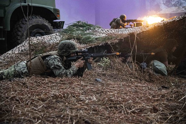 CAMP SHELBY, Miss. (Feb. 7, 2023) Seabees assigned to Naval Mobile Construction Battalion 133 (NMCB 133) and Marines from the 8th Engineer Support Battalion (8th ESB), augmenting NMCB-133, defend an expeditionary advanced base of operations during a simulated attack at Camp Shelby, Miss., Feb. 7, 2023. NMCB-133 is at Camp Shelby conducting a field training exercise operating as part of Navy Expeditionary Combat Command conducting the advanced phase of the force readiness training plan (FRTP). (U.S. Navy photo by Mass Communication Specialist 2nd Class Andrew Waters)                                                                        