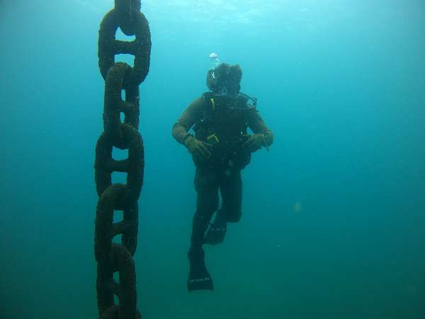SAO TOME, São Tomé and Principe (Dec. 21, 2023) Hospital Corpsman 1st Class Nathaniel Yarbrough, assigned to Underwater Construction Team (UCT) 1, follows a buoy chain to surface during an underwater survey of a coast guard pier in São Tomé, Sao Tome and Principe,  Dec. 21, 2023. UCT-1 is on a scheduled deployment in the U.S. Naval Forces Europe area of operations, employed by the U.S. 6th Fleet to defend U.S., allied and partner interests. (U.S. Navy photo by Mass Communication Specialist 2nd Class Andrew Waters)                      