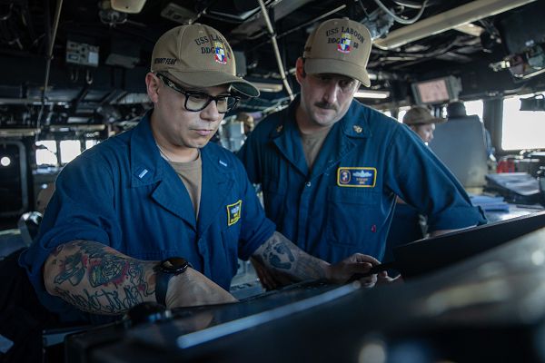 BAB AL-MANDEB STRAIT (Dec. 27, 2023) Lt. j.g. Ronnie Brooks, left, and Chief Quartermaster Kyle Lux monitor navigation aboard the Arleigh Burke-class guided-missile destroyer USS Laboon (DDG 58) as the ship transits the Bab Al-Mandeb Strait while operating in support of Operation Prosperity Guardian (OPG), Dec. 27, 2023. Led by Combined Task Force 153 of the Combined Maritime Forces, OPG represents a focused, international effort to address maritime security challenges in the southern Red Sea and the Gulf of Aden, with the goal of ensuring freedom of navigation for all countries and bolstering regional security. More than 20 countries have confirmed their participation in the operation. (U.S. Navy photo by Mass Communication Specialist 3rd Class Alice Husted)              