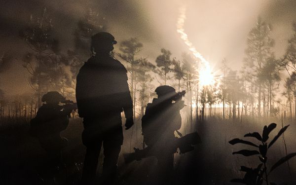 U.S. Marines with 3rd Battalion, 2d Marine Regiment, 2d Marine Division scan for targets as a flare lights up the field during the Marine Corps Combat Readiness Evaluation (MCCRE) on Camp Lejeune, North Carolina, Dec. 13, 2023. The MCCRE involves a range of scenarios and challenges that test the unit's ability to plan, coordinate, and execute complex missions, including offensive and defensive operations, logistics, and communications. (U.S. Marine Corps video by Pfc. Eric Valerio)