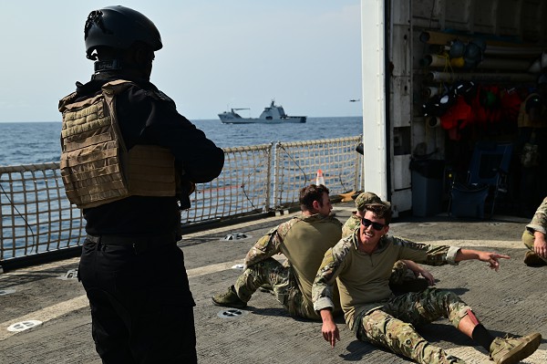 Coast Guardsmen and a member of the Nigerian Navy conduct law enforcement training aboard USCGC Spencer (WMEC 905) as part of Obangame Express 23 in the Atlantic Ocean, Jan. 29, 2023. Obangame Express 2023, conducted by U.S. Naval Forces Africa, is a maritime exercise designed to improve cooperation, and increase maritime safety and security among participating nations in the Gulf of Guinea and Southern Atlantic Ocean. U.S. Sixth Fleet, headquartered in Naples, Italy, conducts the full spectrum of joint and naval operations, often in concert with allied and interagency partners, in order to advance U.S. national interests and security and stability in Europe and Africa. (photo by Petty Officer Third Class Mikaela McGee)