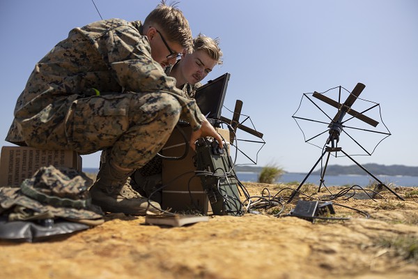 U.S. Marines with command element, 31st Marine Expeditionary Unit, program a radio for communications during a bilateral tactical air control party exercise at W-174, Okinawa, Japan on Mar. 7, 2023. The exercise was conducted to practice finding and tracking notional enemy vessels by using maritime surveillance data in coordinate with the Japan Maritime Self-Defense Force during Iron Fist 23. Iron Fist is an annual bilateral exercise designed to increase interoperability and strengthen the relationships between the U.S. Marine Corps, the U.S. Navy, the Japan Ground Self Defense Force, and the JMSDF. (U.S. Marine Corps photo by Lance Cpl. Bridgette Rodriguez)