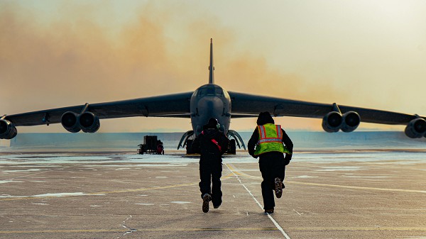 Crew chiefs assigned to the 23rd Aircraft Maintenance Squadron run toward a 23rd Bomb Squadron B-52H Stratofortress at Minot Air Force Base, N.D., Feb. 23, 2023, to remove the chocks and launch the aircraft to Moron Air Base, Spain, to participate in Bomber Task Force 23-2. The U.S. maintains a strong, credible strategic bomber force that enhances the security and stability of allies and partners. (U.S. Air Force photo by Staff Sgt. Michael A. Richmond) 