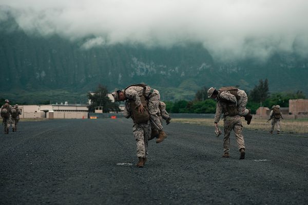 U.S. Marines stationed at Marine Corps Base Hawaii escort simulated casualties to safety in a combat evacuation patrol during the Marine Corps Air Station Kaneohe Bay Corporals Course 2-23, Marine Corps Training Area Bellows, MCBH, April 7, 2023. The course was held to provide Marine noncommissioned officers with the skills and knowledge necessary to become successful small-unit leaders. (U.S. Marine Corps photo by Lance Cpl. Clayton Baker)