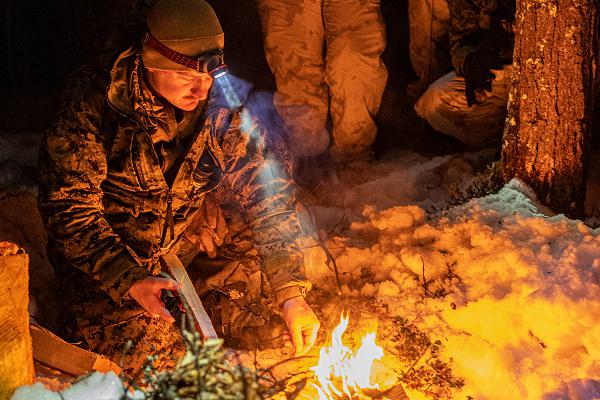 U.S. Marine Corps Sgt. Zachary Harper, a Chemical, Biological, Radiological and Nuclear specialist and a NATO Winter Instructor Course instructor with 1st Battalion, 2nd Marine Regiment, 2nd Marine Division, teaches Marines how to build a fire in an arctic environment in preparation for the NATO exercise Nordic Response 2024 in Setermoen, Norway, Jan. 28, 2024. Nordic Response is a Norwegian national readiness and defense exercise designed to enhance military capabilities and allied cooperation in high-intensity warfighting in a challenging arctic environment. This exercise will test military activities ranging from the reception of allied and partner reinforcements and command and control interoperability to combined joint operations, maritime prepositioning force logistics, integration with NATO militaries, and reacting against an adversary force during a dynamic training environment. The U.S. stands firm in commitment and readiness to support Norway, allies and partners. (U.S. Marine Corps photo by Lance Cpl. Joshua Kumakaw)