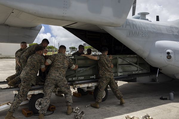 U.S. Marines with Marine Medium Tiltrotor Squadron (VMM) 265, 1st Marine Aircraft Wing, and 3rd Battalion, 12th Marines, test a prototype loading system, which allows the High Mobility Artillery Rocket System (HIMARS) launch pod to be loaded into the back of an MV-22B Osprey, at Marine Corps Air Station (MCAS) Futenma, Okinawa, Japan, July 18, 2023. The system was designed by GySgt. Rodrigo HernandezPolindara, VMM-265, to offer a more efficient method of transporting HIMARS. (U.S. Marine Corps photo by Lance Cpl. Sav Ford)