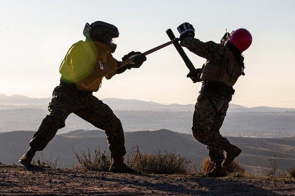 U.S. Marine Corps Sgt. Avery Luengo, left, a martial arts instructor trainer with 1st Battalion, 1st Marine Regiment, 1st Marine Division, and U.S. Marine Corps Cpl. Alexis Flippo, an imagery analysis specialist with 1st Intelligence Battalion, I Marine Expeditionary Force Information Group, conduct weapon-free sparring during a martial arts instructor course physical training session at Marine Corps Base Camp Pendleton, California, Dec. 8, 2022. MAI courses certify Marines to instruct and monitor Marine Corps Martial Arts Program training and advance Marines in the program, distinguishing their levels of experience with different colored belts. (photo by Lance Cpl. Gadiel Zaragoza)