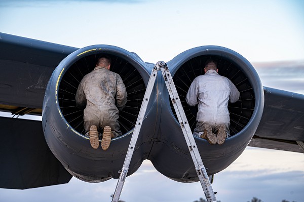 U.S Air Force Staff Sgt. David Petrie and Staff Sgt. Timothy Petterson, 23rd Expeditionary Bomb Squadron crew chiefs, inspect the engine of a B-52H Stratofortress after landing at Morón Air Base, Spain, March 7, 2023. Bomber missions demonstrate the credibility of forces to address a global security environment that is more diverse and uncertain than at any other time in recent history. (U.S. Air Force photo by Airman 1st Class Alexander Nottingham) 