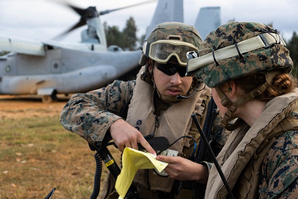 U.S. Navy Lt. Catherine Cloetta, a triage officer, and U.S. Marine Corps Cpl. Angel Marmolejo, a radio system operator, both with the 31st Marine Expeditionary Unit, coordinate an extraction during a ship to shore casualty care and extraction exercise at Camp Hansen, Okinawa, Japan, Jan. 25, 2023. The exercise simulated a mass casualty incident to maintain readiness and to improve response time. The 31st MEU is operating aboard ships of USS America Amphibious Ready Group in the 7th fleet area of operations to enhance interoperability with allies and partners and serve as a ready response force to defend peace and stability in the Indo-Pacific region. (photo by Lance Cpl. William Wallace)