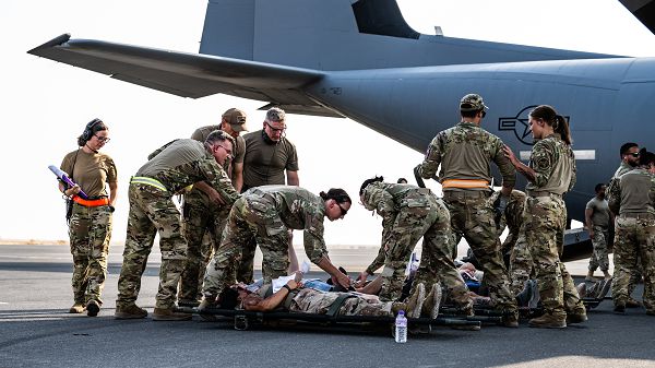 U.S. Air Force Medical personnel from the 386th Expeditionary Medical Squadron field response team and the 405th Expeditionary Aeromedical Evacuation Squadron prepare to load victims from a simulated attack onto a C-130J Super Hercules during a contingency response development at Ali Al Salem Air Base, Kuwait, Aug. 9, 2023. This mass-casualty training event provided joint participants from multiple wings and squadrons with the chance to put their life-saving medical capabilities to the test, ensuring the safety of the U.S. and coalition forces. (U.S. Air Force photo by Staff Sgt. Kevin Long) 