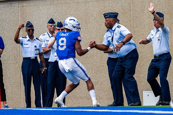 Air Force quarterback Zac Larrier celebrates with Lt. Gen. Richard M. Clark, Air Force Academy superintendent, after scoring a touchdown against Robert Morris University on Sept. 2, 2023, during a game in Falcon Stadium at the U.S. Air Force Academy, Colorado Springs, Colo. Air Force defeated Robert Morris 42-7 in their regular season opener and the win marks their 17th straight season-opening win. (U.S. Air Force photo by Trevor Cokley) 