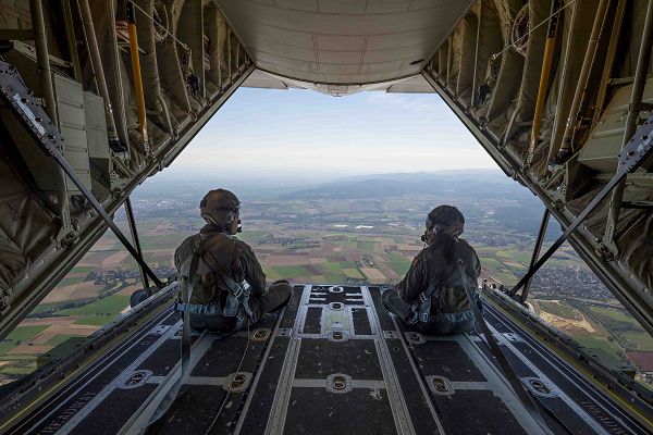 U.S. Air Force Staff Sgt. Andrew Flint and Airman 1st Class Andrea Medranda, 37th Airlift Squadron loadmasters, sit on a C-130J Super Hercules ramp during a simulated cargo drop during a Hispanic heritage flight over Germany, Sept. 6, 2023. In celebration of National Hispanic Heritage Month, an all-Hispanic crew including the loadmasters, pilots, maintainers and medical personnel participated in an aeromedical flight training sortie, providing real-world aeromedical evacuation practice. (U.S. Air Force Senior Airman Edgar Grimaldo) 