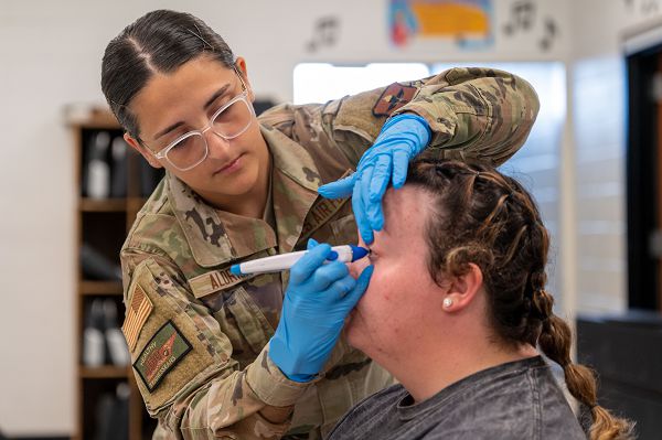 Airman 1st Class Peyten Aldrich, 81st Medical Group ophthalmology technician, checks the pressure of a patient's eye during Innovative Readiness Training's Healthy Tennesseans event at Bledsoe County High School in Pikeville, Tenn., June 4, 2023. The IRT program provides an array of services to communities in need including civil engineering, medical and cybersecurity missions while also serving the service members who volunteer for the missions by providing real-world training opportunity to enhance readiness. (U.S. Air Force photo by Tech. Sgt. Kristen Pittman)