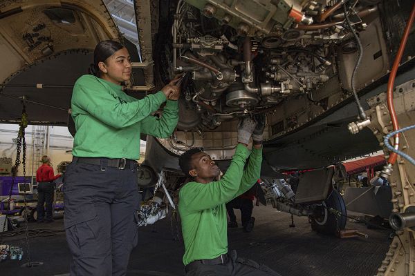 PACIFIC OCEAN (Aug. 23, 2023) Aviation Machinist's Mate 2nd Class Ashley Miranda, left, from Cocoa Beach, Fla., and Aviation Machinist's Mate Airman Jan Michael Simmonds, from Baltimore, remove an engine from an F/A-18F Super Hornet from the “Fighting Redcocks” of Strike Fighter Squadron (VFA) 22 aboard the aircraft carrier USS Nimitz (CVN 68). Nimitz is underway conducting routine operations. (U.S. Navy photo by Mass Communication Specialist Seaman Tomas Valdes)