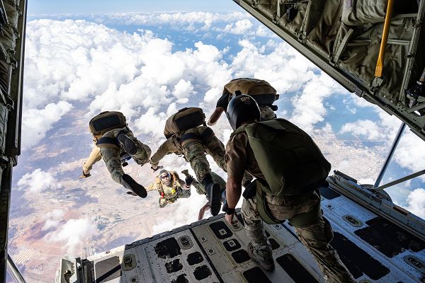 U.S. Air Force operators assigned to the 82nd Expeditionary Rescue Squadron and Joint Personnel Recovery Center perform high altitude, low opening training jumps from a U.S. Marine Corps KC-130J Hercules cargo aircraft over East Africa, Dec. 27, 2023. HALO jumps are performed from altitudes where oxygen is limited, requiring members to employ specialized training beyond standard parachute insertions. (U.S. Air Force photo by Staff Sgt. Allison Payne)