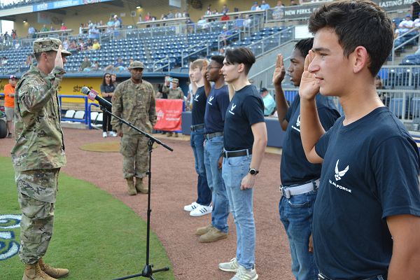 Col. Jason Allen, 81st Training Wing vice commander, performs an oath of enlistment ceremony for new trainees from the local area prior to a Biloxi Shuckers baseball game at MGM Park in Biloxi, Mississippi, July 26, 2022. The trainees are currently in the Delayed Entry Program awaiting their Basic Military Training ship date. (U.S. Air Force photo by Master Sgt. Eric Burks)