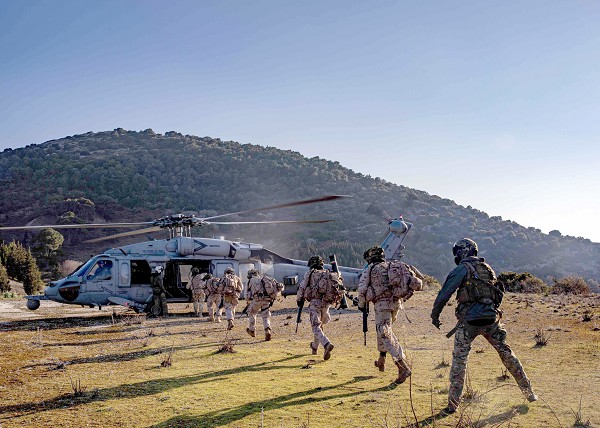 ALBANIA (Feb. 22, 2023) Spanish marines board an MH-60S Sea Hawk helicopter during interoperability training, Feb. 22, 2023. Carrier Air Wing (CVW) 7 is the offensive air and strike component of Carrier Strike Group (CSG) 10 and the George H.W. Bush CSG. The squadrons of CVW-7 are Strike Fighter Squadron (VFA) 143, VFA-103, VFA-86, VFA-136, Carrier Airborne Early Warning Squadron (VAW) 121, Electronic Attack Squadron (VAQ) 140, Helicopter Sea Combat Squadron (HSC) 5, and HSM-46. The George H.W. Bush CSG is on a scheduled deployment in the U.S. Naval Forces Europe area of operations, employed by U.S. Sixth Fleet to defend U.S., allied and partner interests. (U.S. Navy photo by Mass Communication Specialist 2nd Class Novalee Manzella)