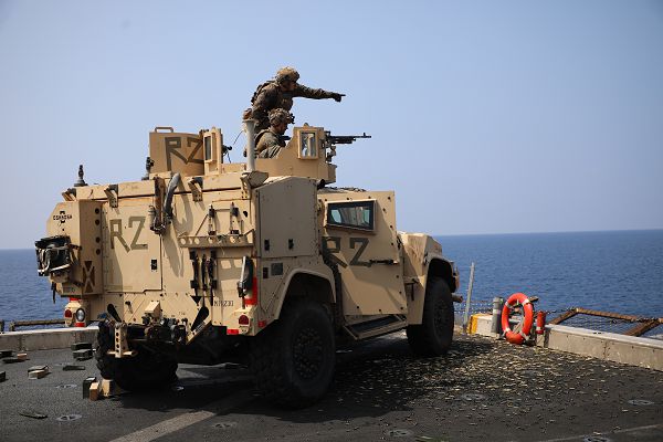 South China Sea (April 18, 2023) – U.S. Marine Corps Staff Sgt. Gordon Adams, top, a machine gunner assigned to Battalion Landing Team 2/4, 13th Marine Expeditionary Unit, points at targets as Cpl. Vince Silva, a machine gunner assigned to BLT 2/4, 13th MEU, fires an M240B machine gun mounted to a Joint Light Tactical Vehicle during a deck shoot aboard the amphibious transport dock USS John P. Murtha (LPD 26), April 18, 2023. The 13th MEU is embarked with the Makin Island Amphibious Ready Group, comprised of the amphibious assault ship USS Makin Island (LHD 8) and the amphibious transport dock ships USS Anchorage (LPD 23) and John P. Murtha, and operating in the U.S. 7th Fleet area of operations. 7th Fleet is the U.S. Navy’s largest forward-deployed numbered fleet, and routinely interacts and operates with Allies and partners in preserving a free and open Indo-Pacific region. (U.S. Marine Corps photo by Cpl. Quince D. Bisard)