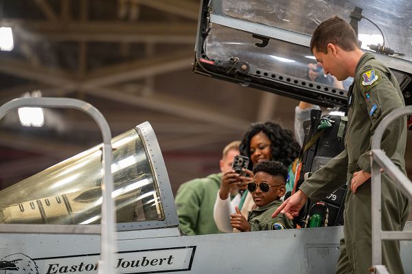 The 125th Fighter Wing, in collaboration with the Make-A-Wish organization, fulfilled the wish of 10-year-old Easton to become a fighter pilot at the Jacksonville Air National Guard Base, Fla., Dec. 7, 2023. Easton underwent an exciting transformation as he stepped into the shoes of an F-15C Eagle fighter pilot for the day. The day included a swear-in ceremony, a tour of the flight line where he had the opportunity to watch jets takeoff, a sit inside the cockpit of an F-15, and tours of the fire department and air traffic control tower located at Jacksonville International Airport. For the tour, Easton wore a custom-made flight suit as an honorary “eagle driver” and was granted the aviator call sign “Vibin’” by pilots of the 159th Fighter Squadron. (U.S. Air National Guard photo by Tech Sgt. Chelsea Smith) 