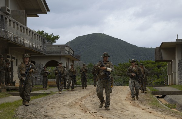 U.S. Marines with 3d Battalion, 4th Marines patrol through an urban training area during Stand-in Force Exercise on Okinawa, Japan, Dec. 6, 2022. SiF-EX is a Division-level exercise involving all elements of the Marine Air-Ground Task Force focused on strengthening multi-domain awareness, maneuver, and fires across a distributed maritime environment. This exercise serves as a rehearsal for rapidly projecting combat power in defense of allies and partners in the region. (photo by Cpl. Davin Tenbusch)