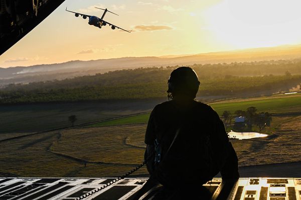 U.S. Air Force Tech Sgt. Joseph Hoffman, 535th Airlift Squadron Advance Instructor Course loadmaster, sits on the ramp of a C-17 Globemaster III during a training flight over Australia for exercise Global Dexterity 23-1, April 27, 2023. This is the sixth iteration of the exercise between the U.S. Air Force and its Indo-Pacific partners, which is a vital effort given the changing strategic environment in the region. (U.S. Air Force photo by Senior Airman Makensie Cooper) 
