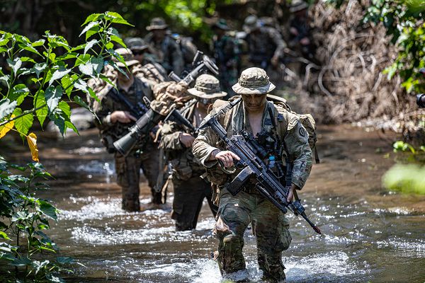 A group of U.S. Army Soldiers, assigned to 2nd Platoon, Borzoi Company, 2nd Brigade, 25th Infantry Division, and a Indonesian Service Members cross a river while on patrol during Exercise Super Garuda Shield on the 5th Marine Combat Training Center (Puslatpur), Situbondo Regency, East Java, Indonesia., September 4, 2023. Super Garuda Shield 2023 is an annual exercise that has significantly grown in scope and size since 2009. SGS2023 is the second consecutive time this exercise has grown into a combined and joint event, highlighting the 7 participating and 12 observing nations' commitment to partnership and a free and open Indo-Pacific. (U.S. Army Reserve photo by Sgt. 1st Class Austin Berner)