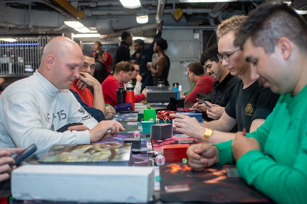231004-N-YX844-1098 PHILIPPINE SEA (Oct. 4, 2023) Sailors play Magic the Gathering during an event hosted by Morale, Welfare, and Recreation on the forward mess decks of the U.S. Navy’s only forward-deployed aircraft carrier, USS Ronald Reagan (CVN 76), in the Philippine Sea, Oct. 4, 2023. Ronald Reagan, the flagship of Carrier Strike Group 5, provides a combat-ready force that protects and defends the United States, and supports alliances, partnerships and collective maritime interests in the Indo-Pacific region. (U.S. Navy photo by Mass Communication Specialist 3rd Class Evan Mueller)
