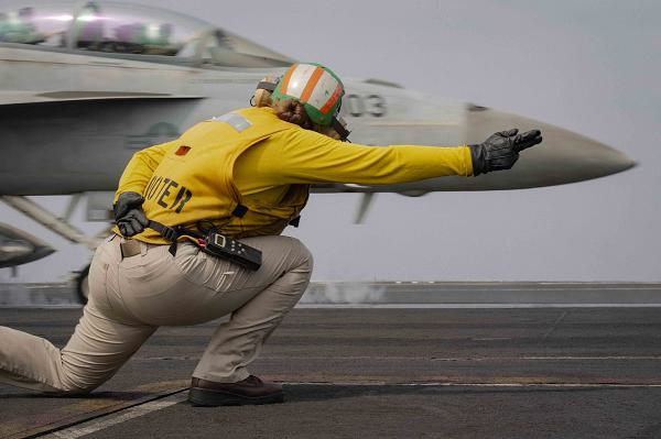 RED SEA (March 5, 2024) A shooter signals the launch of an F/A-18F Super Hornet from the &quot;Fighting Swordsmen&quot; of Strike Fighter Squadron (VFA) 32 from the flight deck during flight operations aboard the Nimitz-class aircraft carrier USS Dwight D. Eisenhower (CVN 69) in the Red Sea, March 5, 2024. The Dwight D. Eisenhower Carrier Strike Group is deployed to the U.S. 5th Fleet area of operations to support maritime security and stability in the Middle East region. (U.S. Navy photo)                                