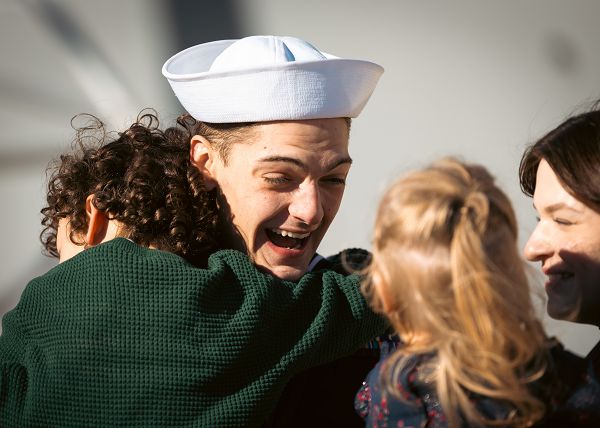 NAVAL STATION MAYPORT, Fla. (Jan. 4, 2023) A Sailor assigned to the Arleigh-Burke class guided-missile destroyer USS Thomas Hudner (DDG 116) is greeted by his family after arriving at Naval Station Mayport from an eight-month deployment, Jan. 4, 2024. Thomas Hudner deployed as a part of the Gerald R. Ford Carrier Strike Group (CSG) to the U.S. Naval Forces Europe-Africa area of operations in support of theater security cooperation efforts and to defend U.S., allied, and partner interests. (U.S. Navy photo by Mass Communication Specialist 1st Class Brandon J. Vinson)                    
