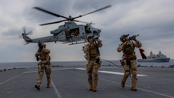 U.S. Marines with the maritime raid force, 31st Marine Expeditionary Unit conduct a search during a visit, board, search, and seizure exercise aboard the tank landing ship JS Osumi (LST-4001) during Iron Fist 23 in the Pacific Ocean, Mar. 4, 2023. Iron Fist 23 provided an opportunity for the USS America Amphibious Ready Group and the JMSDF to work together in coordinating combined counter-piracy operations at sea. Iron Fist is an annual bilateral exercise designed to increase interoperability and strengthen the relationships between the U.S. Marine Corps, the U.S. Navy, the Japan Ground Self-Defense Force, and the JMSDF. (U.S. Marine Corps photo by Sgt. Marcos A. Alvarado)