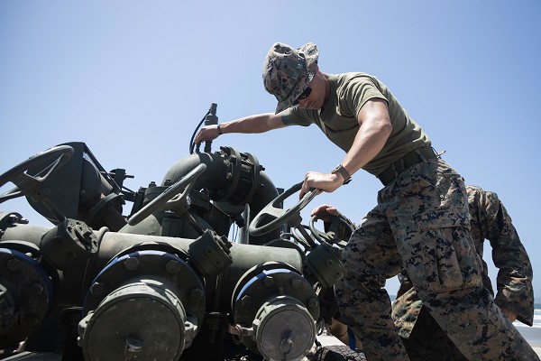 U.S. Marine Corps Benjamin McDonald, a bulk fuel specialist with Bulk Fuel Company, 7th Engineer Support Battalion, 1st Marine Logistics Group, pumps excess sea water out of a liquid bladder during tactical bulk fuel operations on Silver Strand State Beach, California, May 4, 2022. Demonstrations of both existing and new bulk liquid distribution systems were utilized to aid development of fuel distribution in contested littoral environments. (U.S. Marine Corps photo by Sgt. Maximiliano Rosas)