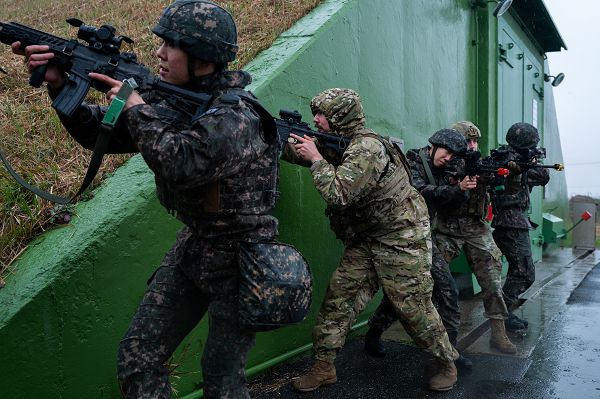 South Korea air force Air 38th Fighter Group military police and U.S. Air Force 8th Security Forces Squadron security forces Airmen hold a defensive position during an anti-terrorism response exercise at Kunsan Air Base, South Korea, Nov. 16, 2023. The training required the two units to fully integrate and focus on improving combined base defense capabilities at Kunsan AB. (U.S. Air Force photo by Staff Sgt. Samuel Earick) 