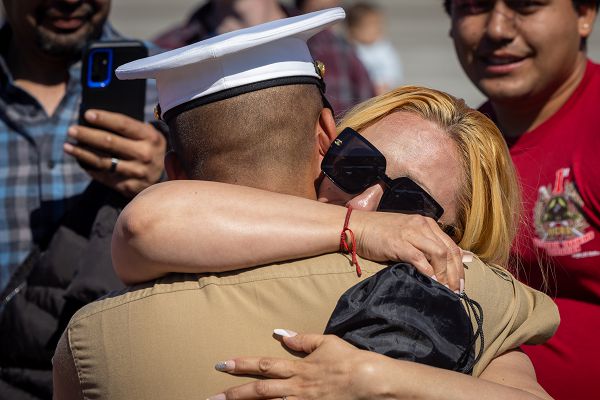 A new U.S. Marine from Bravo Company, 1st Recruit Training Battalion, is greeted by a guest after a graduation ceremony at Marine Corps Recruit Depot San Diego, Oct. 6, 2023. Graduation took place at the completion of the 13-week transformation, which included training for drill, marksmanship, basic combat skills, and Marine Corps customs and traditions. (U.S. Marine Corps photo by Cpl. Alexander O. Devereux)