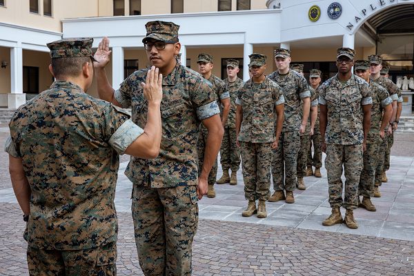 U.S. Marine Corps Cpl. Eduardo Garcia, Data System Administrator, 2nd Marine Expeditionary Brigade (2d MEB), recites the Oathe of Enlistment during his reenlistment ceremony under the under the Commandant’s Retention Program (CRP) at Naval Support Site (NSA) Naples, on July 21 2023. The CRP makes reenlisting much easier for selected Marines by expediting the reenlistment process, and offers them meaningful incentives to reenlist such as assignment prioritization, in order to help retain the most talented first term marines. (U.S. Marine Corps photo by Lance Cpl. Jack Labrador)