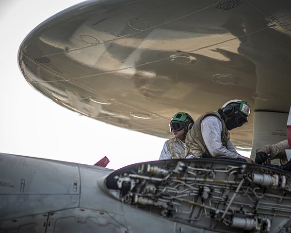 SOUTH CHINA SEA (April 17, 2023) Sailors perform maintenance on an E-2C Hawkeye from the “Sun Kings” of Carrier Airborne Early Warning Squadron (VAW) 116 on the flight deck aboard the aircraft carrier USS Nimitz (CVN 68). Nimitz is in U.S. 7th Fleet conducting routine operations. 7th Fleet is the U.S. Navy's largest forward-deployed numbered fleet, and routinely interacts and operates with allies and partners in preserving a free and open Indo-Pacific region. (U.S. Navy photo by Mass Communication Specialist 3rd Class Hannah Kantner)