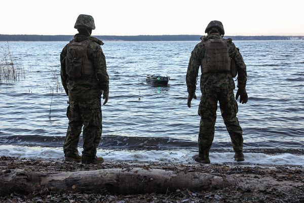 U.S. Marine Corps Cpl. Gabriel Hawks, left, and Cpl. William Morris, both motor vehicle operators with Combat Logistics Battalion 6, Combat Logistics Regiment 2, 2nd Marine Logistics Group, prepare to retrieve the “Amy”, an unmanned surface vehicle, out of a lake in Syndalen, Finland, Nov. 17, 2023. 2nd MLG Marines experiment with the capabilities of the “Amy”, including cargo weight, range, and power, in order to advance littoral reconnaissance.