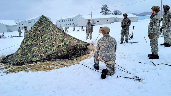 Airmen with multiple Air National Guard and Air Force Reserve security forces units learn to build an Arctic 10-person tent Jan. 19, 2023, as part of a 16-day Cold-Weather Operations Course led by the Air Force at Fort McCoy, Wis. More than 50 Airmen are participating in the training from across the Air Force. Besides learning about use of snowshoes and moving as a squad over terrain pulling an ahkio sled in a cold-weather environment, the Airmen also learned about cold-weather shelters, survival techniques, cold-weather uniform wear, and more. Fort McCoy has a long history of supporting cold-weather training. Eighty years prior to this training, in January 1943, the installation hosted winter training for the Army's 76th Division prior to the Division deploying to Europe to fight in the Battle of the Bulge in World War II. (Photo by Scott T. Sturkol, Fort McCoy Public Affairs Office)