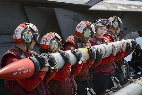 Sailors load a missile onto an F/A-18E Super Hornet aboard the USS Nimitz in the Persian Gulf, Aug. 8, 2017. The aircraft carrier is deployed in the U.S. 5th Fleet area of responsibility to support Operation Inherent Resolve. Photo by Petty Officer 3rd Class Weston A. Mohr