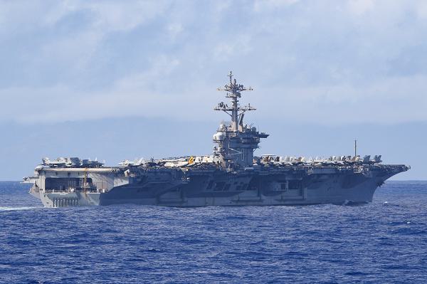 241222-N-BT947-1043 SURIGAO STRAIT (Dec. 22, 2024) The Nimitz-class aircraft carrier USS Carl Vinson (CVN 70) transits the Surigao strait, Dec. 22, 2024. The Carl Vinson Carrier Strike Group is underway conducting routine operations in the U.S. 7th Fleet area of operations. (U.S. Navy photo by Mass Communication Specialist 1st Class Jacob I. Allison)