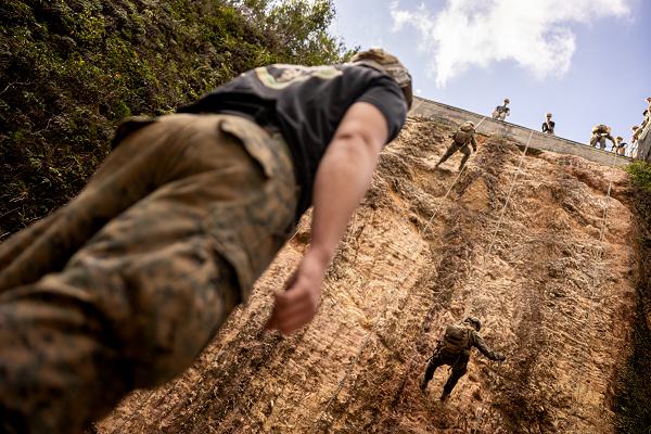 U.S. Marine Corps Sgt. Brian Evans supervises Marines rappelling as the belay pit non-commissioned officer during a company jungle exercise at the Jungle Warfare Training Center, Okinawa, Japan, Dec. 17, 2024. The week-long course teaches Marines survival skills and increases proficiency in fighting in a jungle environment. Evans, a native of a native of Ohio and a machine gunner, is forward deployed in the Indo-Pacific as part of 4th Marine Regiment, 3d Marine Division under the Unit Deployment Program. (U.S. Marine Corps photo by Sgt. Noah Masog)