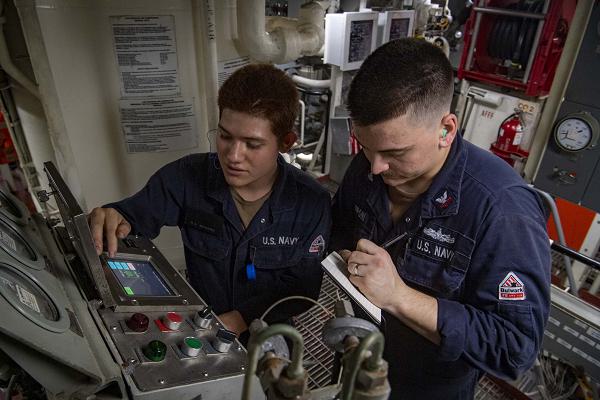 Gas Turbine Systems Technician (Mechanical) Fireman Manuel Gutierrez, from Henderson, Nev., left, trains Electrician’s Mate 2nd Class Robbie Zepponi, from Rescue, Calif., on how to note readings an air compressor in a main engineering space aboard the Arleigh Burke-class guided-missile destroyer USS Sterett (DDG 104), Jan. 11, 2025. The Carl Vinson Carrier Strike Group is underway conducting routine operations in the U.S. 7th Fleet area of operations. (U.S. Navy photo by Mass Communication Specialist 3rd Class Brianna Walker)                                               