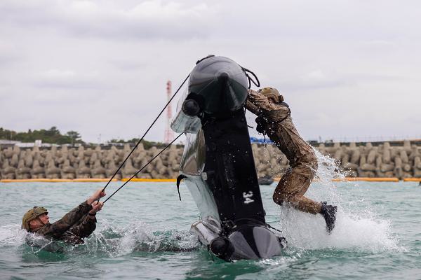 U.S. Marines practice flipping over combat rubber raiding crafts during small boat handling training on Camp Schwab, Okinawa, Japan, January 23, 2025. The training familiarized Marines with basic CRRC operations, handling, maneuvering, and emergency procedures. The Marines are with 3d Reconnaissance Battalion and 3d Marine Division. (U.S. Marine Corps photo by Sgt. Noah Masog)