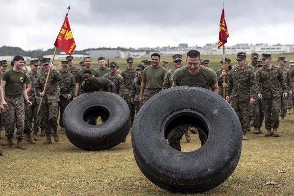 U.S. Marines with Marine Air Support Squadron 2, Marine Aircraft Group 36, 1st Marine Aircraft Wing flip tires during a field meet at Marine Corps Air Station Futenma, Okinawa, Japan, Jan. 24, 2025. The field meet was held in celebration of MASS-2's 82nd Anniversary. (U.S. Marine Corps photo by Lance Cpl. Sav Ford)