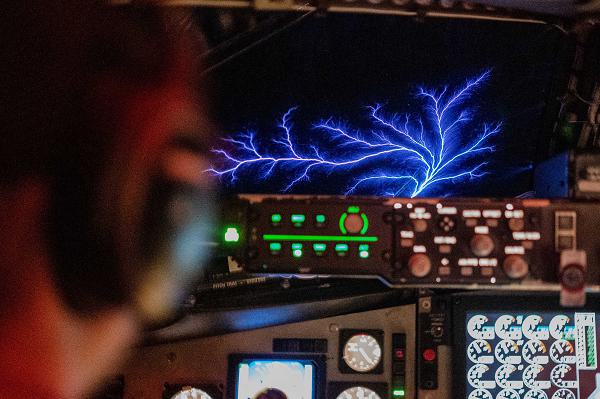 U.S. Air Force Capt. Russell Ellis, a KC-135 Stratotanker pilot, flies a routine tanker mission over the U.S. Central Command area of responsibility as St. Elmo's Fire, a weather phenomenon observable in atmospheric electric fields, flashes across the window, Jan. 22, 2025. The KC-135 Stratotanker is the backbone of U.S. Air Forces Central's global reach aerial refueling capability and delivers critical support to joint and coalition aircraft in order to guarantee war-winning airpower throughout the CENTCOM AOR. (U.S. Air Force photo by Staff Sgt. Jackson Manske)