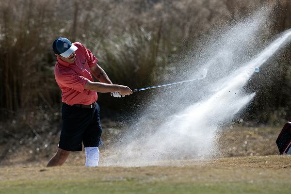 Air Force Tech. Sgt. Dalton Dishman hits out of a sand trap on hole 13 at The Legends Golf Course at Parris Island during the 2025 Armed Forces Golf Championship at Marine Corps Recruit Depot, Parris Island, S.C., Feb. 26, 2025. (DoD photo by EJ Hersom)