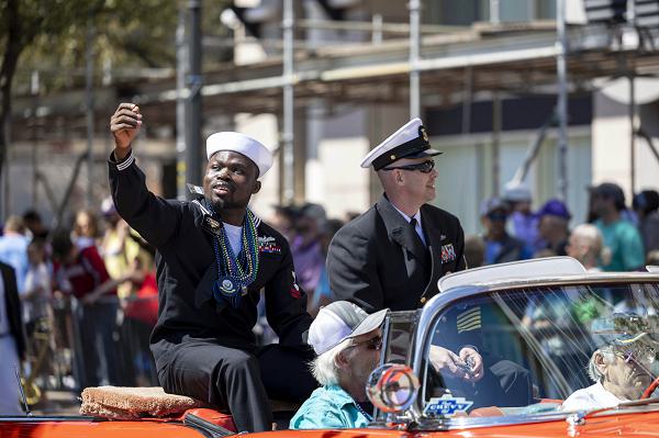 250301-N-EE423-1050 MOBILE, Ala. (March 1, 2024) Command Master Chief Brian Barrineau-Juhas and Electrician's Mate 2nd Class Aboudoulaye Ibrahim assigned to USS McFaul (DDG 74), participate in Mobile, Alabama's Floral Parade, March 1, 2025. McFaul is in Mobile, Alabama, participating in its 2025 Mardi Gras celebration. (U.S. Navy photo by Mass Communication Specialist 1st Class Sophie A. Pinkham)