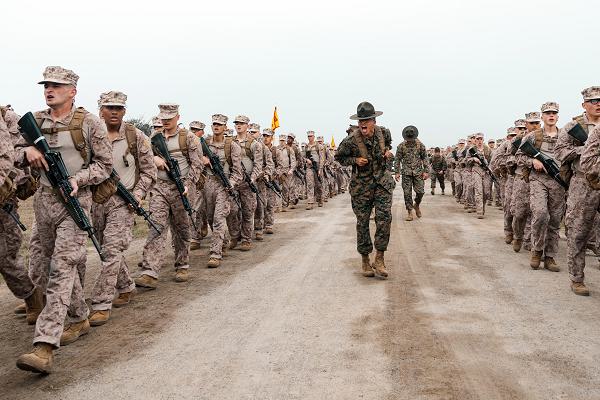 U.S. Marine Corps Drill Instructor Sgt. Angel Felix, with Golf Company, 2nd Recruit Training Battalion, recites Marine Corps knowledge to recruits during a two-kilometer introduction hike at Marine Corps Recruit Depot San Diego, California, Feb. 27, 2025. During training, recruits conduct a series of progressively longer hikes to physically and mentally condition them to create combat readiness for any necessary future operations as the world’s force in readiness. (U.S. Marine Corps photo by Lance Cpl. Janell B. Alvarez)